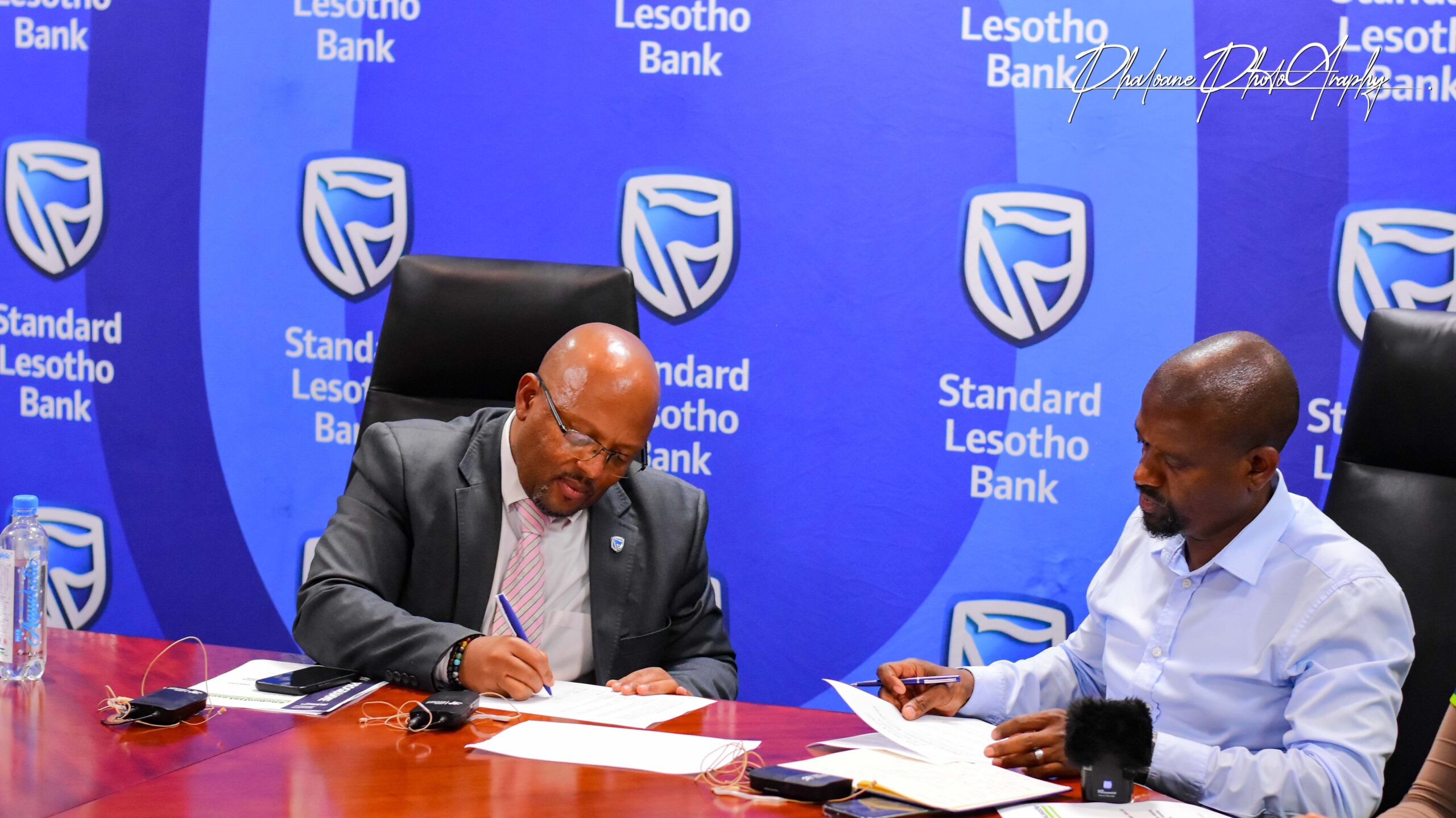 Two men signing the agreement