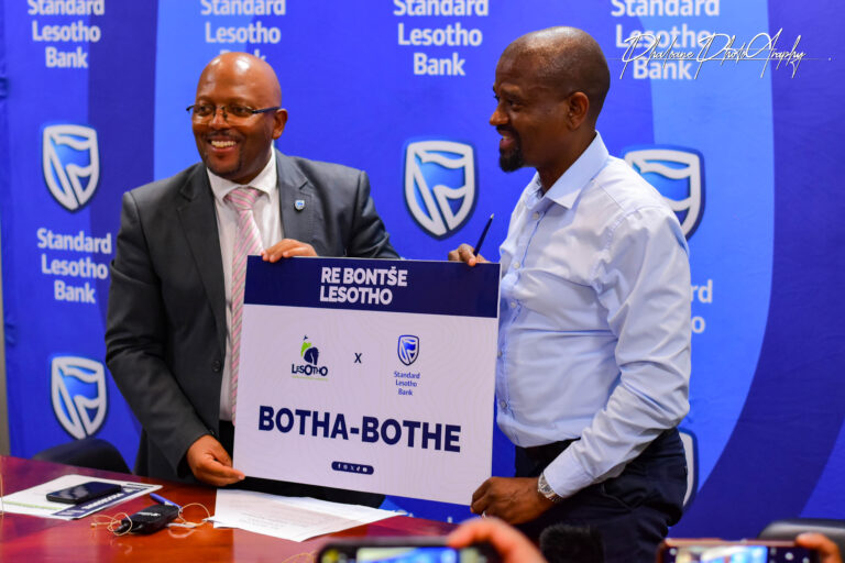 Two Men holding agreement singed board